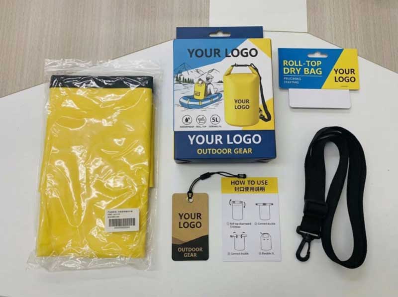 Printed colour box, hang tag and header card beside a packed dry bag